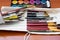 Paint brushes and watercolor paints, tempera paints on the table in a workshop