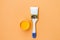 Paint can and brush on orange background. House renovation concept. Set of tools and paints for making repair in flat