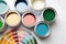 Paint cans and color palette on white background