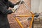Paint removal: man using steel wool over a bike frame after using a blowtorch