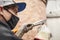 Paint removal: man using a wire brush over a bike frame after using a blowtorch