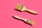 Paint varnishing brushes with wooden handle on trendy fuchsia pink background. Interior design home refurbishing fashion concept