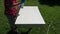 Paint in white vintage wooden table in garden on grass