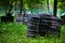 Paintball shooting range. Paintball territory in the forest. Iron barrels in the foreground with multi-colored blots