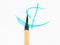 Paintbrush with cyan tip over cyan brush strokes