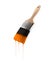 Paintbrush loaded with orange color dripping off the bristles.