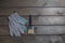 a paintbrush and rag work gloves on a brown wooden table. top view