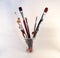 Paintbrushes in a glass jar on white background