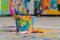 Paintbucket falling on the concrete floor, colorful paint splashing arround
