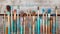 Painted art brushes lined up neatly on wood, world art day photography