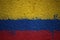 painted big national flag of colombia on a massive old cracked wall