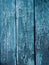 Painted blue wood surface, with an abstract expressive vertical line texture. Pastel background for design