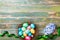 Painted colorful Easter eggs in nest with hyacinth flowers and ribbon top view. Festive background for spring holiday.