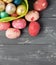 Painted Easter Eggs in decorated green basket on wooden table.