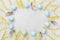 Painted Easter eggs, mimosa flower and feather on vintage stone background top view in flat lay style. Clean space for text.