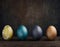 Painted Easter eggs in muted colors on dark backdrop