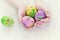 Painted Easter eggs with spring pictures in a child\'s hands