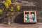 Painted eggs in a box on a table with a vase of flowers. Against the background of old boards. Concept on the theme of Easter