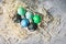 Painted eggs in tray, chicken eggs, paint and brush on concrete surface, Easter decorations. Top