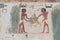 painted Egyptian limestone relief with an agricultural scene