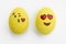 Painted emoji easter eggs in different moods and facial expressions such as kissing, smiling or being in love, in isolated white