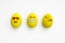 Painted emoji easter eggs in different moods and facial expressions such as kissing, smiling or being in love, in isolated white