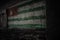 Painted flag of abkhazia on the dirty old wall in an abandoned ruined house