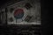 Painted flag of south korea on the dirty old wall in an abandoned ruined house