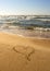 Painted heart on the golden sand of the Baltic beach in Palanga, Lithuania