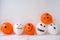 Painted Jacks face on balloons. Orange and white balls preparation diy for halloween party. Halloween home activities