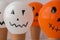 Painted Jacks face on balloons. Orange and white balls preparation diy for halloween party. Halloween home activities