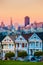 The Painted Ladies of San Francisco, California sit glowing amid