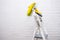 Painted metal stepladder close-up with a hanging set of colorful rollers on the background of a white wall