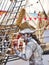 Painted mime man artist showing frozen statue on the street close to the schooner on the Rouen dock for Armada meeting