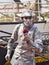 Painted mime man artist showing frozen statue on the street close to the schooner on the Rouen dock for Armada meeting