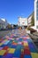 Painted multicolor sidewalk in Akureyri, Iceland on clear sunny autumn morning.