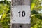 Painted number ten (10) on a concrete column