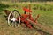 Painted old red vintage plow