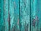 Painted pastel turquoise wood surface, with an abstract expressive vertical line texture. Pastel background for design