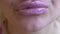 The painted pink lips of a young girl. close up