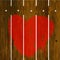 Painted red heart over wooden fence