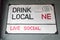 Painted road sign design on a wall advertising drinking local at a bar or pub