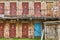 Painted rusty old warehouse doors on two-storey brick building.