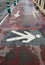 Painted sign on a pedestrian walkway indicating a pedestrian area. High contrast and areal view of tarmac and lines on the ground