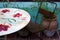 Painted table and metal chair with potted plant and blue wall