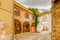 Painted walls on cobbled lane in medieval town