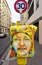 Painted yellow mailbox covered with street art by French graffiti muralist C215 in Paris