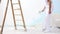 Painter man at work with brush, wall painting concept, white background