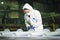 A painter worker in a protective suit checks the quality of the