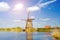 Painting beautiful picture of windmills in Kinderdijk, Netherlands, Europe against the backdrop of a cloudy sky at sunlight